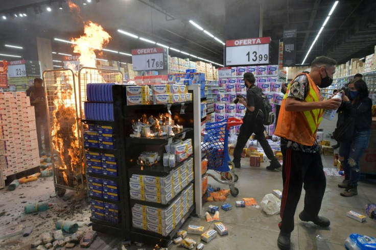 Products burn at a Carrefour supermarket in Sao Paulo during a protest against racism
