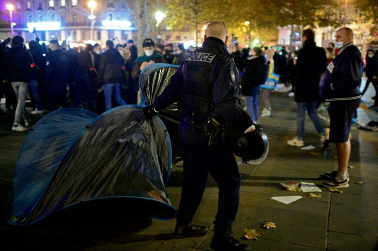 Police removed the tents, sometimes with people still inside, in the face of protests from migrants and jeers from activists