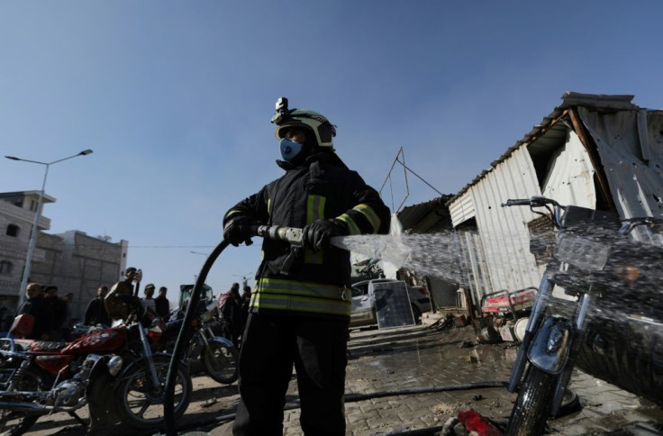 A civil defence member uses a firehose at the scene of a car bomb in the Turkish-controlled town of Al-Bab in the north of Syria's Aleppo province