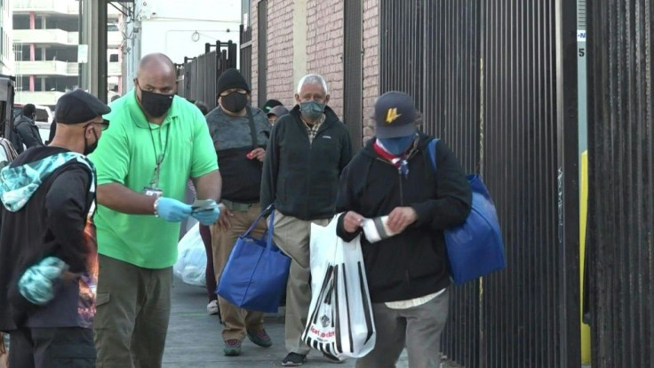 IMAGES AND SOUNDBITESDespite the Covid-19 pandemic, the Los Angeles Mission maintains it's annual food distribution to help nourish those struggling to make ends meet this Thanksgiving. "A hot meal, it warms your heart," says one beneficary.