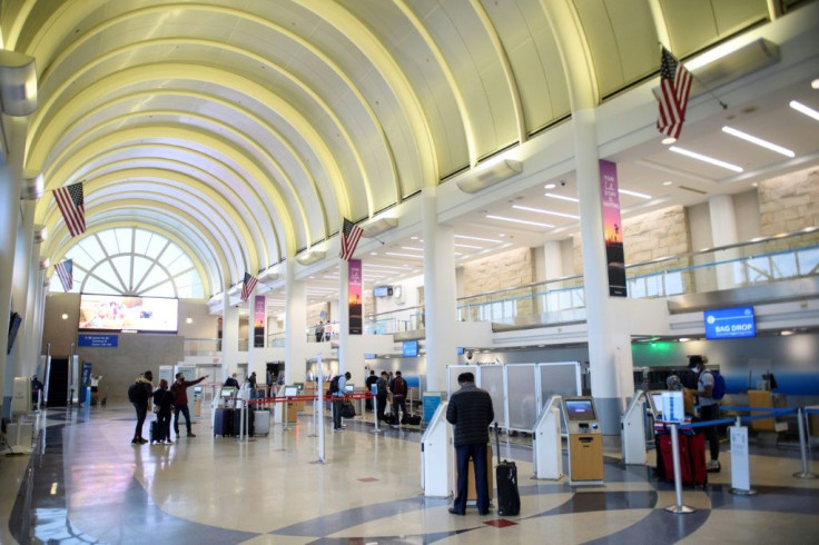 Passengers check in at Los Angeles International Airport ahead of Thanksgiving in Los Angeles, California, November 25, 2020, after US health authorities urged Americans not to travel for the annual holiday