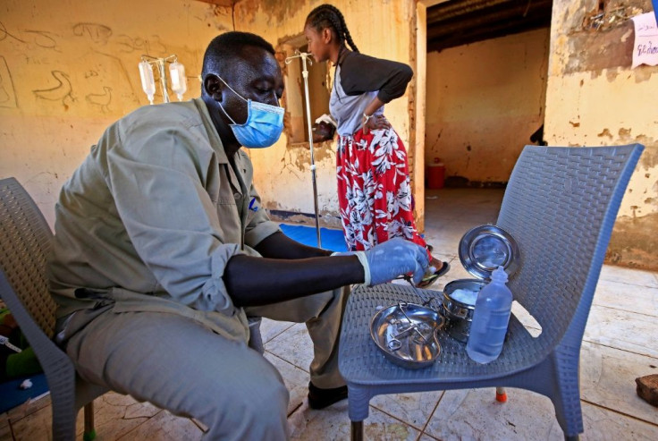 A medic disinfects tools at a medical facility in Um Raquba, a camp that has been set up for Ethiopian refugees in eastern Sudan