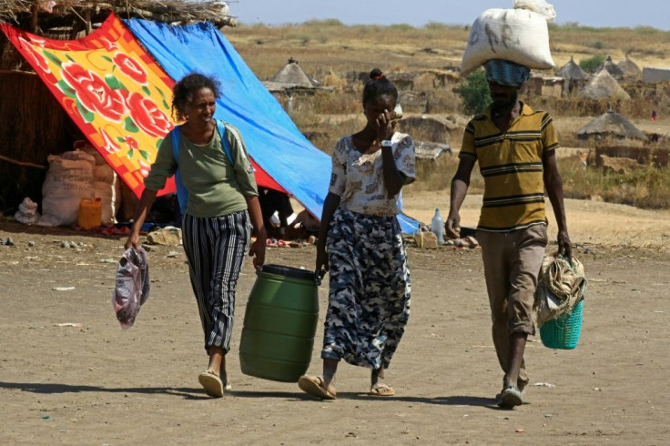 Ethiopian refugees walk through a transit centre at the Sudanese border town of Hamdayit on Thursday.Over 43,000 refugees have crossed into Sudan since fighting broke out in Tigray on November 4, the UN says