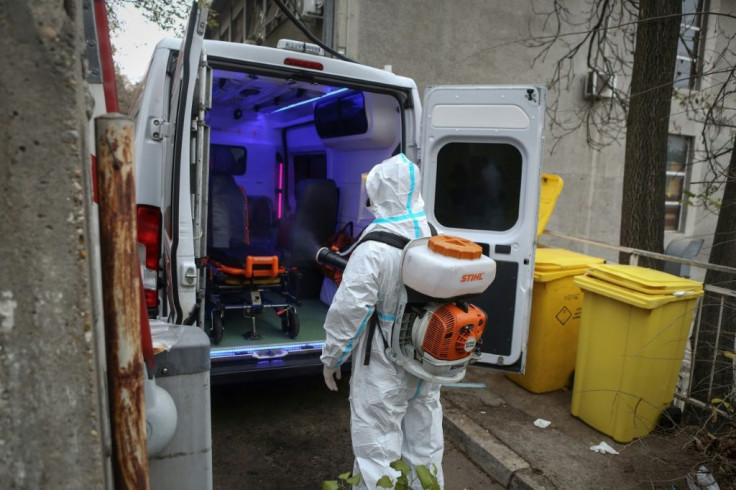 A medical worker disinfects an ambulance in Belgrade