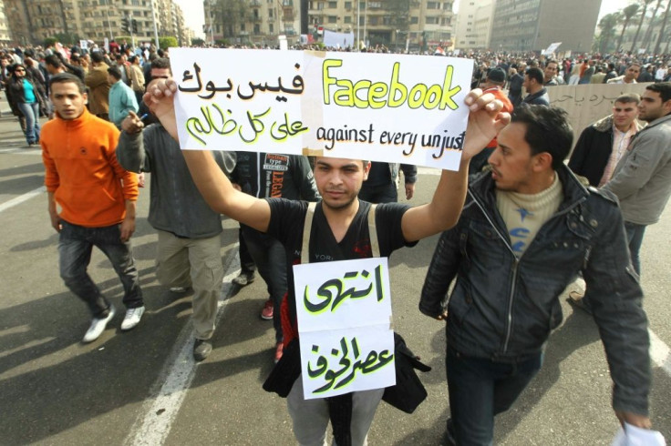 An Egyptian holds up a sign praising Facebook in 2011 on Cairo's Tahrir Square, heeding a call by the opposition for a "march of a million" calling for the ouster of Hosni Mubarak
