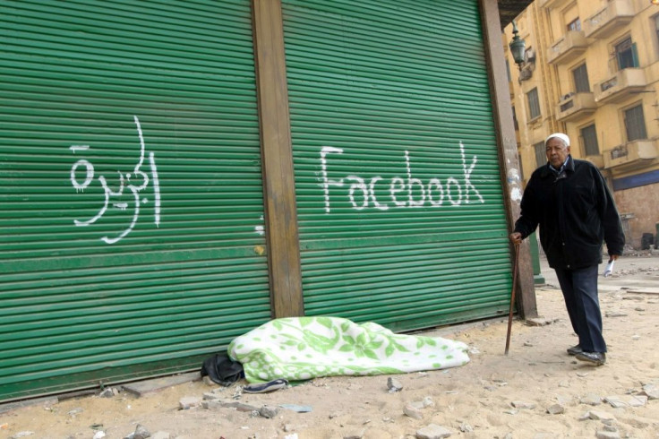 The slogans of TV channel "Al-Jazeera" and social media giant "Facebook" are spray-painted at Cairo's Tahrir Square on February 7, 2011