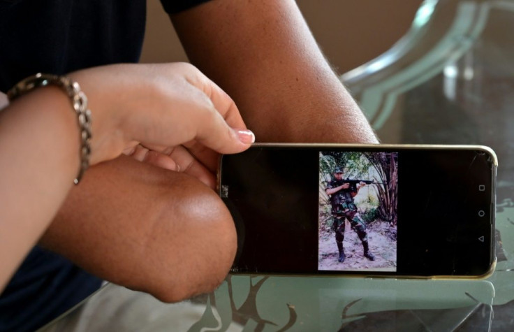 "Mochoman" showing a photo of himself when he was a member of the FARC guerrilla group