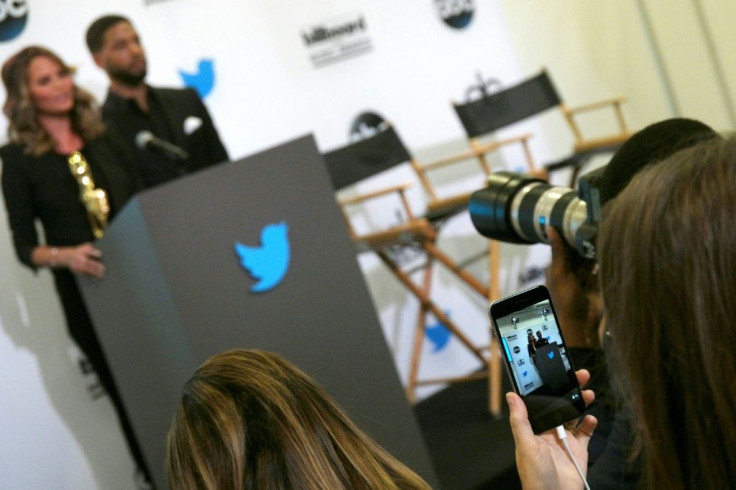 A woman uses the Twitter Periscope app on her mobile phone to live broadcast the announcement of the  Billboard Music Awards finalists in April 2015 in Santa Monica, California