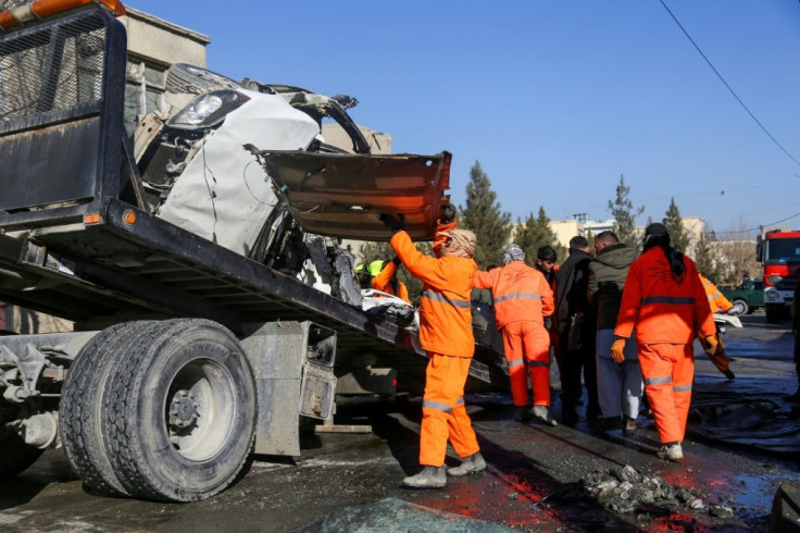 Municipal workers clean up debris at the site of a bomb attack in Kabul on December 22, 2020, the same day US Defense Secretary Christopher Miller met with Afghan leader Ashraf Ghani in the capital