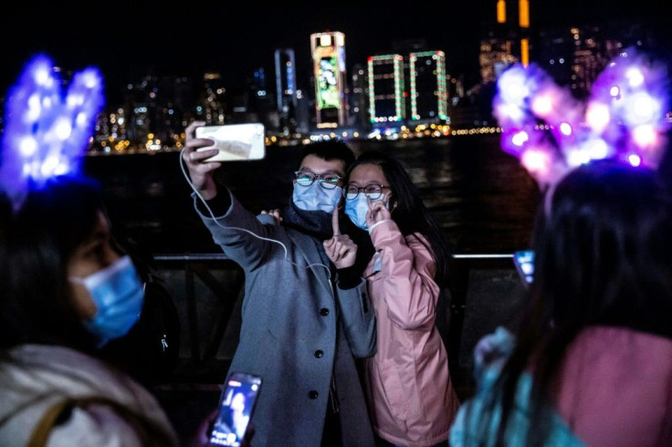 A couple in Hong Kong marked the start of 2021 with a selfie on the water front of Victoria Harbour