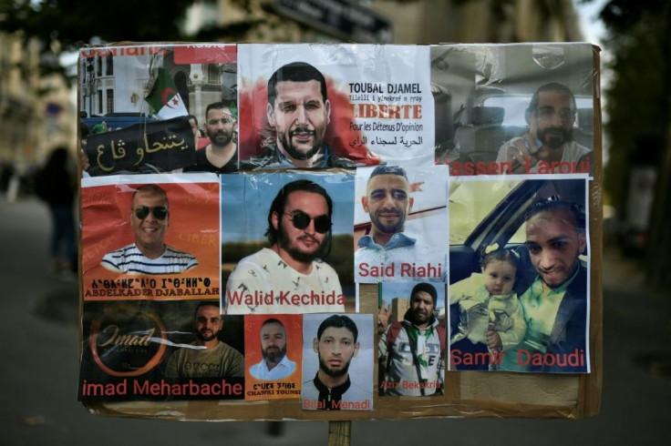 A poster shows portraits of Algerian detainees, including Walid Kechida -- a supporter of Algeria's Hirak protest movement -- outside the Algerian embassy in Paris during a demonstration in August 2020