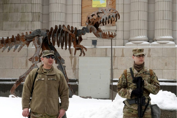 Wisconsin National Guard troops stand guard near the Kenosha County Courthouse in preparation for possible protests over the decision not to prosecute Kenosha police officers in the August 2020 shooting of Jacob Blake.