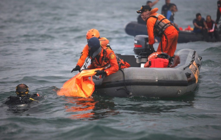 Divers are grappling with strong currents and poor weather to search for bodies and wreckage on the sea floor