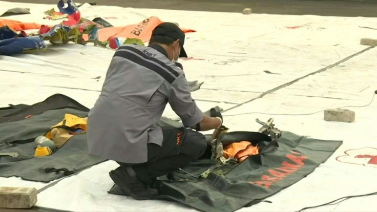 IMAGESOfficials from Indonesia's National Transportation Safety Committee on Tuesday examine debris recovered during the search for Sriwijaya Air flight SJY182 which crashed into the sea minutes after taking off from Jakarta at the weekend.