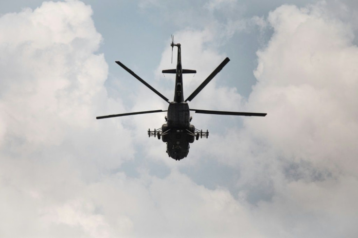 A Russian-made MI-17 helicopter supporting Russian paramilitaries, Rwandan forces and government troops flies over Boali, the gateway to Bangui, on Sunday