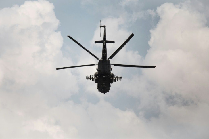 A Russian-made MI-17 helicopter supporting Russian paramilitaries, Rwandan forces and government troops flies over Boali, the gateway to Bangui, on Sunday