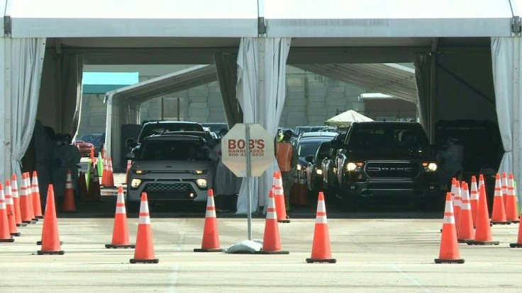 IMAGESCars line up at a drive-in vaccination facility in Miami, Florida. More than 10 million people have received their first dose of a Covid-19 vaccine, according to data collected by the Centers for Disease Control and Prevention (CDC).