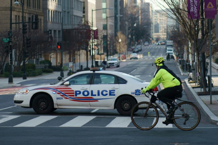 Police patrol cars have blocked off key avenues near the White House and Capitol Hill ahead of Joe Biden's inauguration as US president