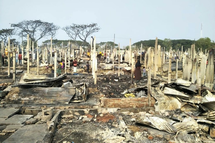 Rohingya refugees search for their belongings after a fire broke out at Nayapara refugee camp in Bangladesh Thursday