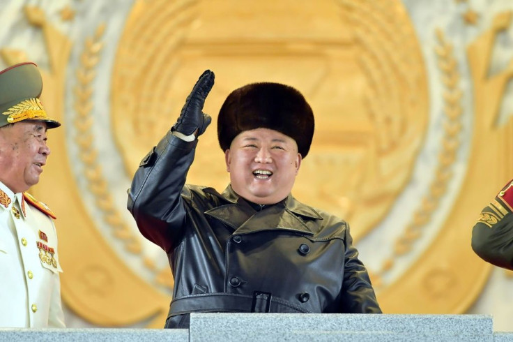 A grinning Kim Jong Un oversaw the parade, wearing a black leather coat and fur hat as he watched infantry troops