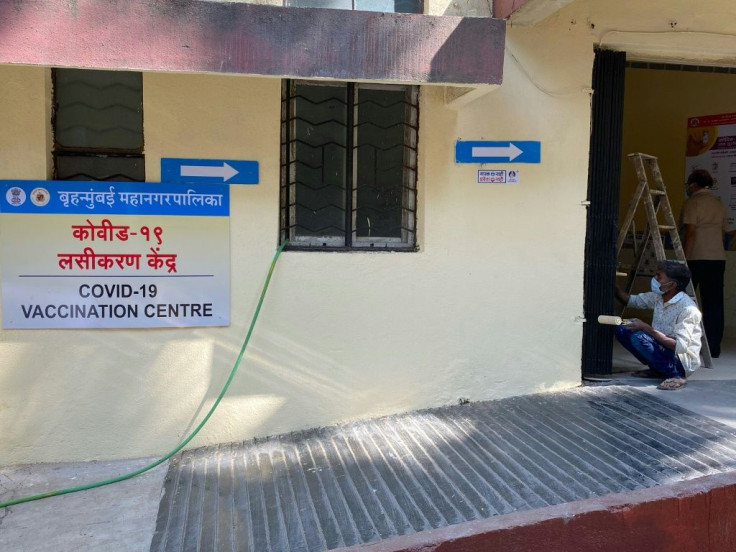 A worker paints the wall of a Covid-19 vaccination centre in Mumbai on January 15, 2021, a day before India starts the first phase of its vaccination programme