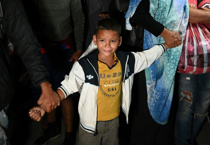 A boy cries as Honduran migrants head to the border with Guatemala