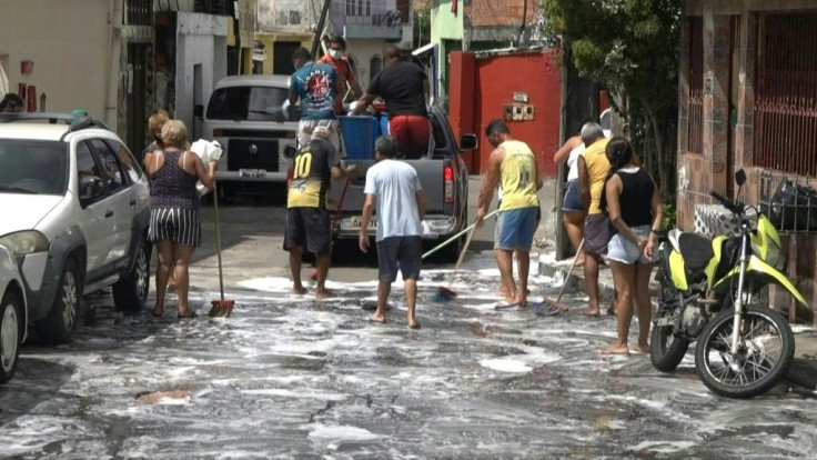Residents of the Brazilian Amazon city of Manaus wash streets in an effort to stop the spread of Covid-19