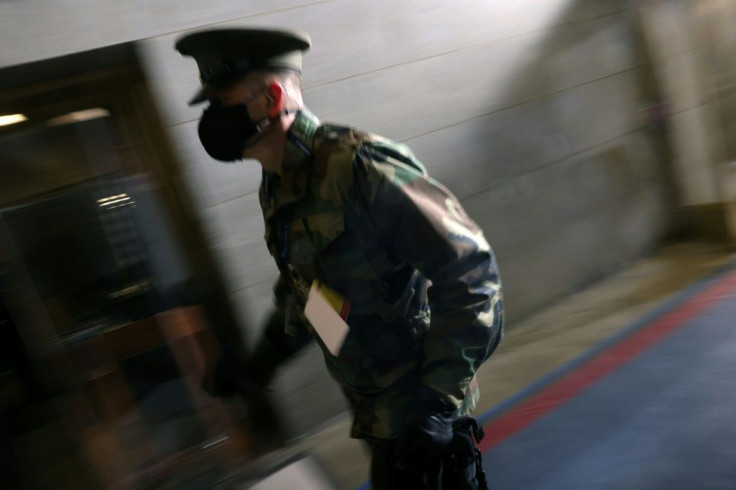 A member of the military rushes during a brief evacuation at the US Capitol