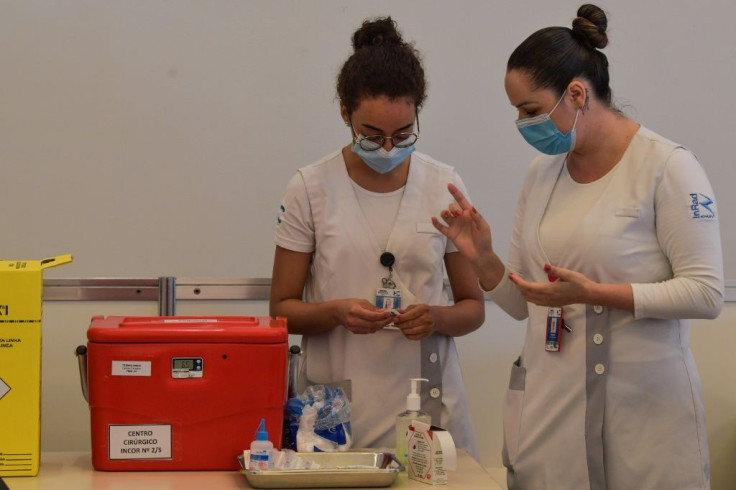 Health workers in Sao Paulo, Brazil, prepare on January 18, 2021 to vaccinate colleagues against the coronavirus