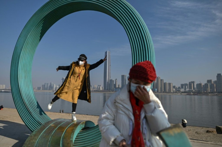 A woman poses for a photo in a park along the Yangtze River in Wuhan in China's central Hubei province