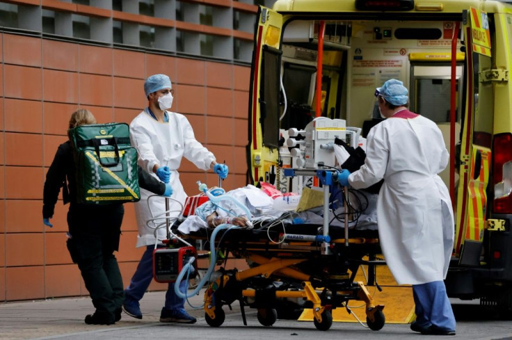 Medics take a patient from an ambulance into the Royal London hospital in London on January 19, 2021