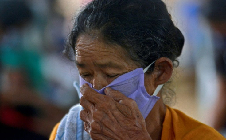 An elderly woman with symptoms of COVID-19 waits to receive medical assistance from members of the International Organization for Migration (IOM) in the riverside community of Bela Vista do Jaraqui in Amazonas state, Brazil, on January 18, 2021