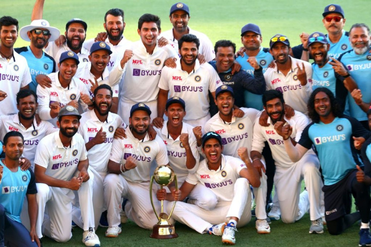 India's players celebrate with the Border-Gavaskar Trophy after their famous series-clinching win against Australia at the Gabba on Tuesday