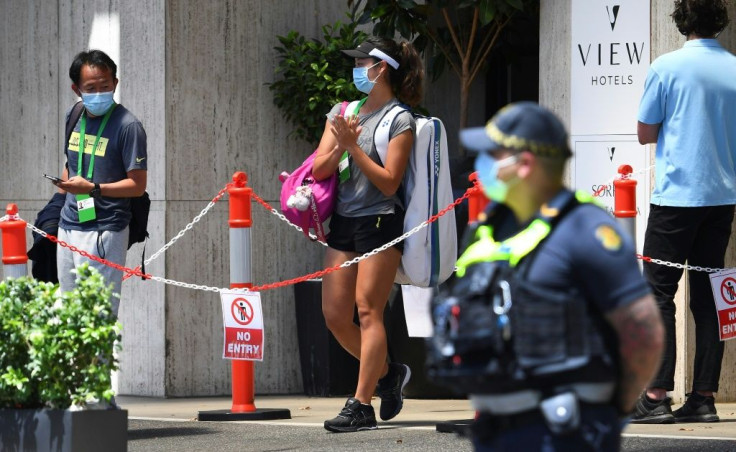 A tennis player leaves her hotel quarantine to go for a training session in Melbourne. Two more players tested positive for  Covid-19 on Wednesday