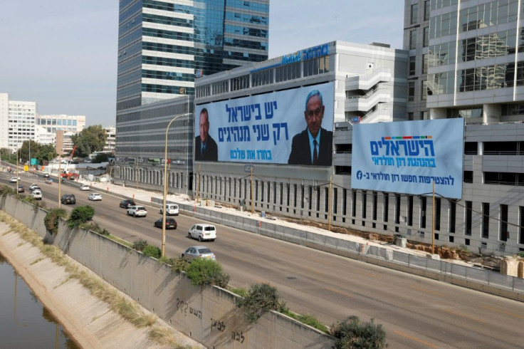 Netanyahu, appearing in an election banner with Tel Aviv Mayor Ron Huldai, is gearing up for his fourth re-election battle in two years ahead of March polls