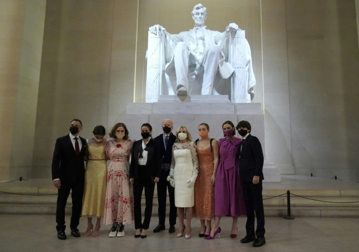 The new "first family" of the United States pose in front of a statue of Abraham Lincoln while wearing face masks following Joe Biden's inauguration