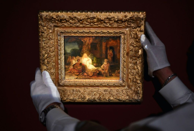 An art handler from Sotheby's arranges Rembrandt van Rijn's "Abraham and the Angels" painting during a press preview at Sotheby's on January 22, 2021 in New York City