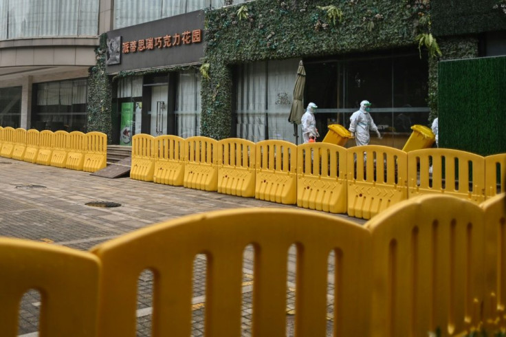 Workers wearing protective gear are seen in the compounds of The Jade Boutique Hotel, where members of the World Health Organization team did theiur quarantine