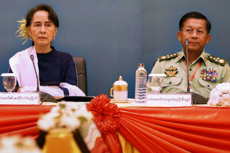 Myanmar's civilian leader Aung San Suu Kyi appears in October 2018 along side Senior General Min Aung Hlaing, who has led a coup in which she was arrested