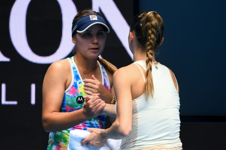 Italy's Camila Giorgi (right) shakes hands with Sofia Kenin of the US after retiring at the end of the first set in their Yarra Valley Classic clash