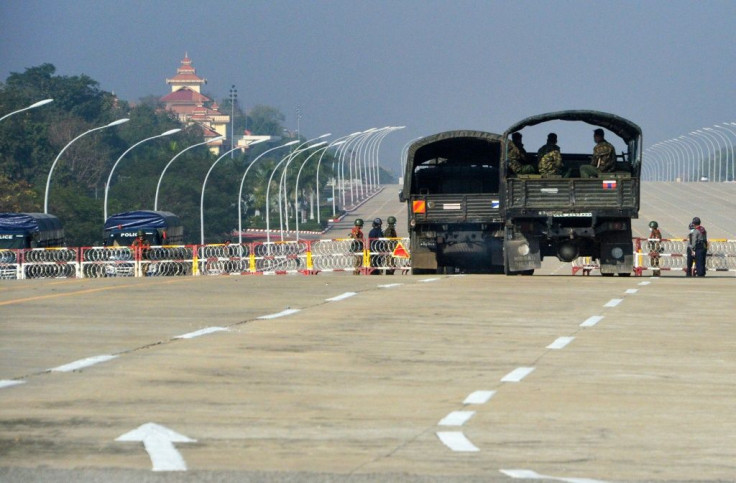 Soldiers stand guard along a blockaded road near Myanmar's parliament in the capital Naypyidaw