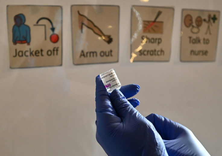 A health worker prepares a dose of the AstraZeneca/Oxford Covid-19 vaccine at a temporary vaccine centre set up at City Hall in Hull, England