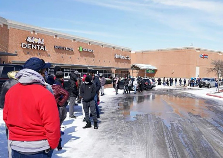 People wait in line at a mall to get inside an H-E-B supermarket in Round Rock, Texas, on February 16, 2021 as millions were left without power as a deadly winter storm gripped the southern and central United States
