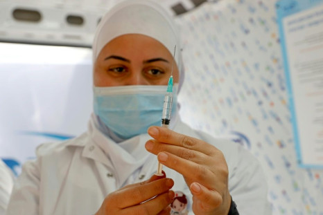 An Israeli health worker prepares to administer a dose of Pfizer-BioNTech coronavirus vaccine inside a van in the Israeli coastal city of Tel Aviv-Jaffa