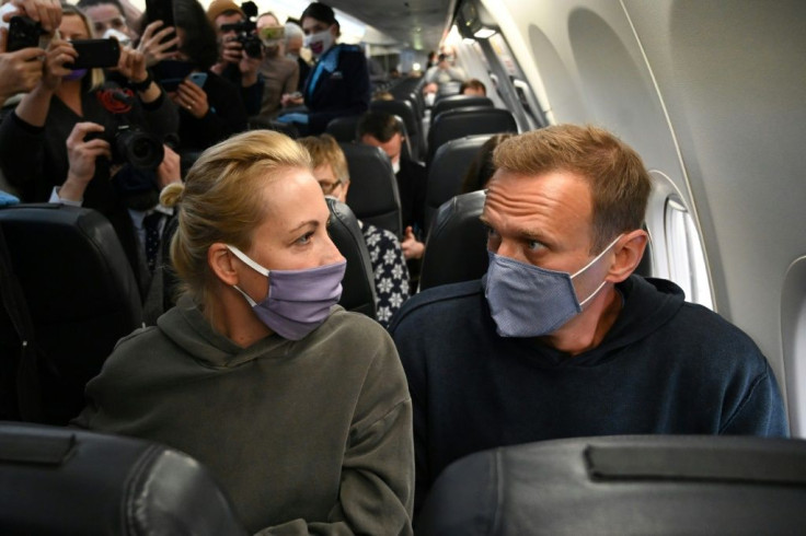 Russian opposition leader Navalny and his wife Yulia on January 17, flying back to Moscow from Berlin where he was treated for poisoning