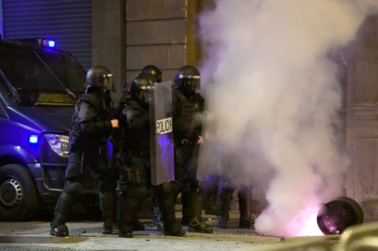 While a group of masked protesters threw bottles, firecrackers and other missiles at officers guarding Barcelona's police headquarters, Sunday's rally was calmer than on previous nights, when the demonstrations escalated into violent clashes