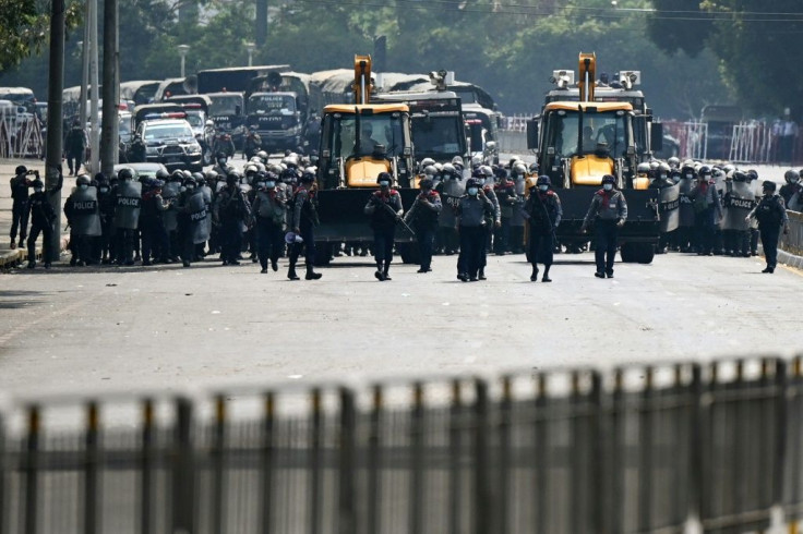 Myanmar police advance towards protesters in Yangon demonstrating against the coup