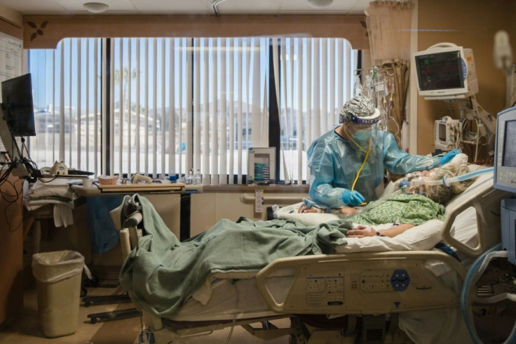 A nurse at the bedside of a coronavirus patient in an intensive care unit at Providence St. Mary's Medical Center in Apple Valley, California on January 11, 2021
