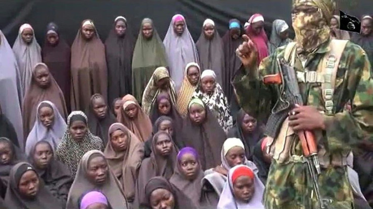 A video grab image from a YouTube clip posted in August 2016, purportedly by Islamist group Boko Haram, shows what is claimed to be one of the group's fighters alongside kidnapped Chibok girls
