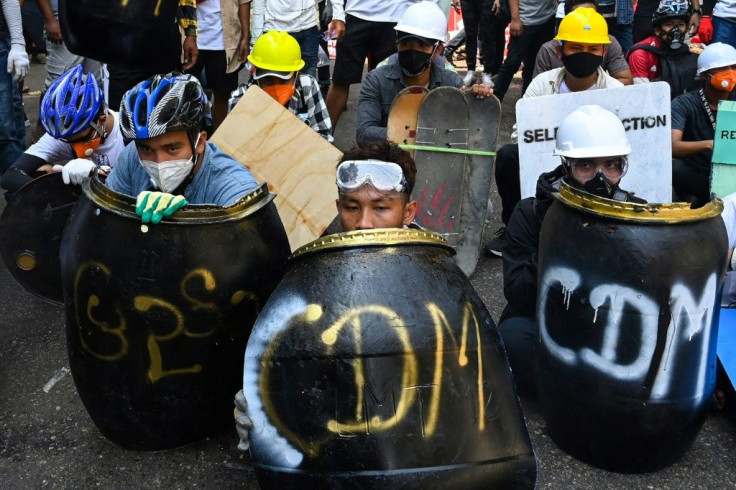 Unarmed protesers using makeshift shields against Myanmar's security forces